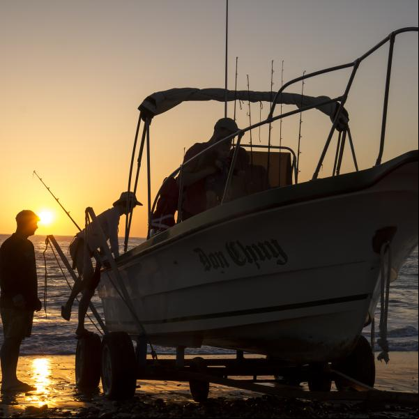 fishermen loading a boat at sunrise